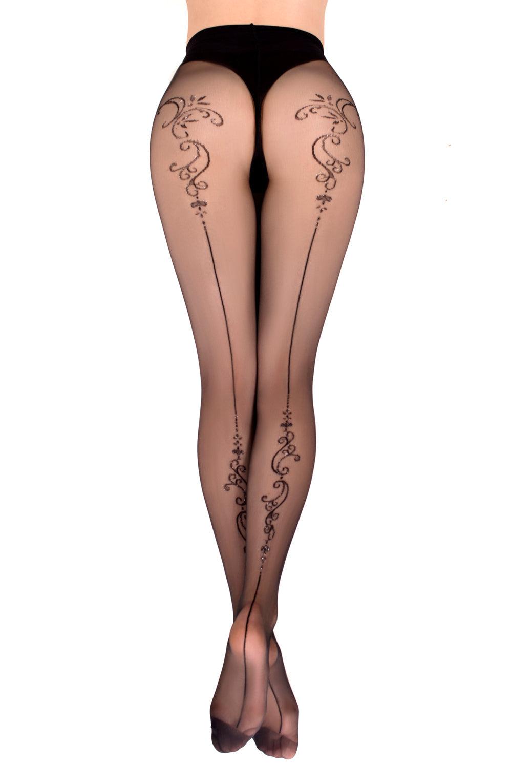 A person is wearing the Ballerina 558 Black Tights, featuring sophisticated sheer black material adorned with intricate black floral and swirl patterns that extend from the upper thigh down to the heels. Captured from behind, the image showcases the full length of this elegant leg design, reminiscent of ballerina packaging.