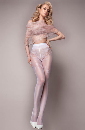 A woman stands in front of a plain background, wearing Ballerina 581 White Tights featuring exquisite patterns from Ballerina's Wedding Touch Collection and white high heels. A shimmery, translucent wrap drapes around her upper body. Her wavy blonde hair is styled elegantly, and she strikes a confident pose.