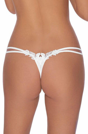 The image shows the back view of a person wearing the elegant Roza Agnez Thong White from Roza. The thong features intricate lace detailing with a floral design on the waistband and a small decorative element at the lower back. The person is standing against a white background, emphasizing the luxurious look.