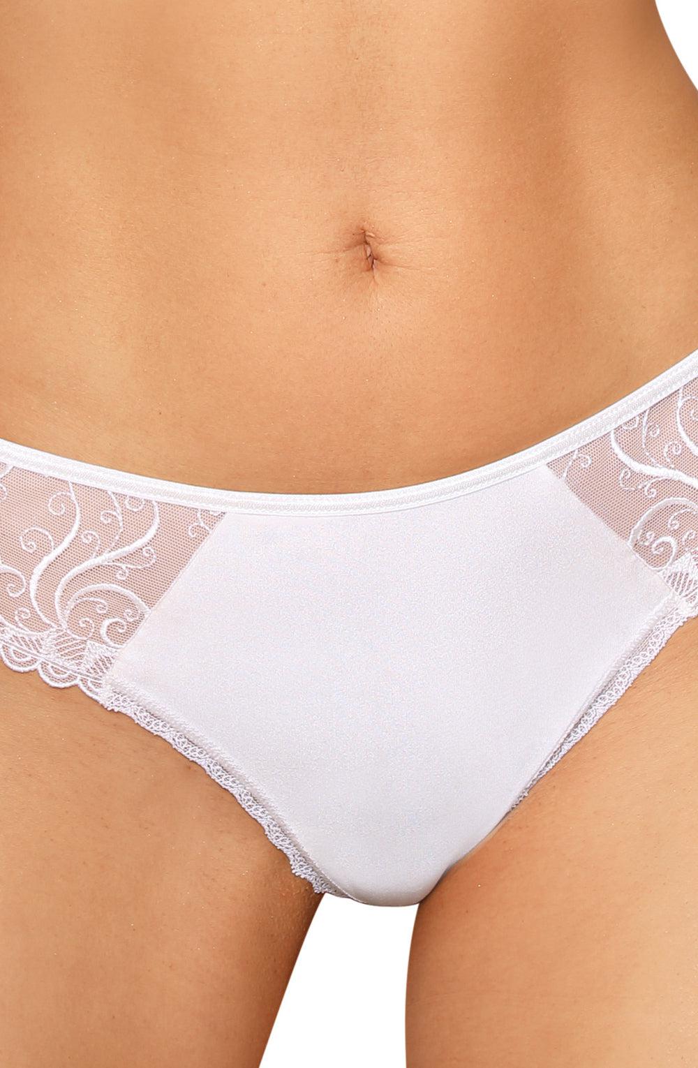 Close-up of a person wearing the luxurious Roza Anuk Thong White featuring white lace-trimmed underwear. The waistband showcases delicate, semi-sheer lace with classic embroidery and a floral pattern, while the front panel is made of smooth, opaque fabric. The person's belly button is visible above the waistband.