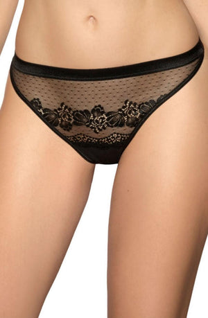 A person is wearing the Roza Ellba Black Thong from the Roza collection, featuring an intricate lace design with floral patterns and sheer mesh fabric. The delicate elastic waistband and leg openings are trimmed with solid black fabric, revealing the midsection and upper thighs.