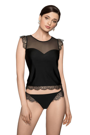 A woman stands wearing the Roza Erii Black Shirt, a sleeveless top featuring eyelash lace trim and semi-sheer mesh detailing at the shoulders and neckline. She pairs it with matching black lace-trimmed panties from her Roza box. Her hair is pulled back, and she accessorizes with earrings.