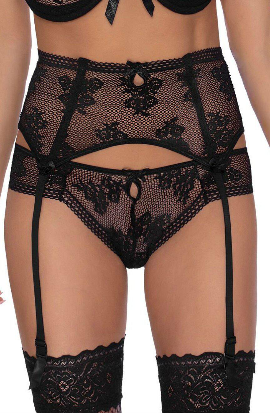 A person wearing the Roza Euterpe Black Suspender Belt set by Roza, featuring a deep bra and garter belt with strap attachments, paired with matching lace panties. The outfit is detailed with small bow accents and floral lace patterns.