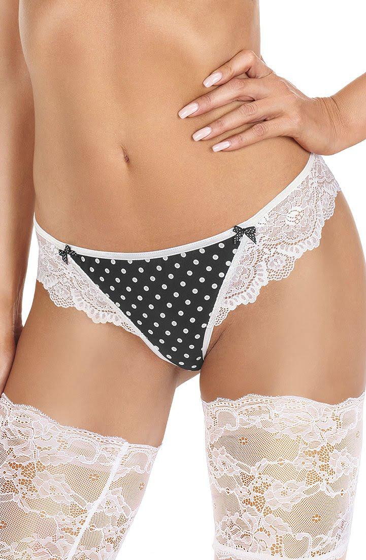 A person wearing the Roza Ewolet Ecru Thong from the Roza brand and white lace thigh-high stockings with an embroidered polka dot design stands with their hand resting on their hip, showcasing the lingerie against a plain white background.