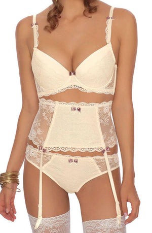 A woman is wearing a matching set of ivory lace lingerie from Roza, featuring the Roza Fifi Push Up Bra Ivory, a garter belt, and panties. The delicate lace design includes small ribbon bows as decorative accents. She is also wearing white lace thigh-high stockings and gold bangles on her wrist.