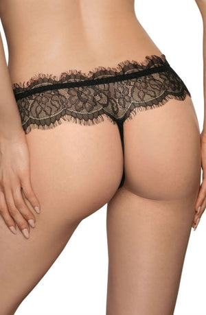 A person is shown from the back, wearing black lace lingerie, including a Roza Idrisa Black Thong by Roza. The intricate lace detail with a scalloped edge adds an elegant touch. The person's hands rest gracefully on their hips.