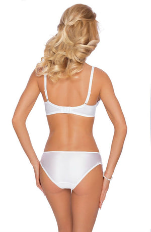 A woman with wavy blonde hair stands with her back to the camera, wearing the Roza Kalisi Soft Cup Bra White and a matching embroidered underwear set. Her left hand rests on her hip, and she wears a pearl bracelet on her left wrist. The background is plain white.