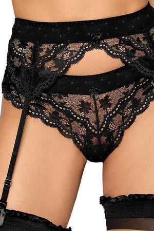 A close-up view of a woman's midsection wearing exquisite lace lingerie, featuring the Roza Lagerta Suspender Belt Black by Roza, panties, and thigh-high stockings. The intricate floral patterns on the lace are enhanced by small decorative bows and a transparent mesh band that adds an extra touch of allure.