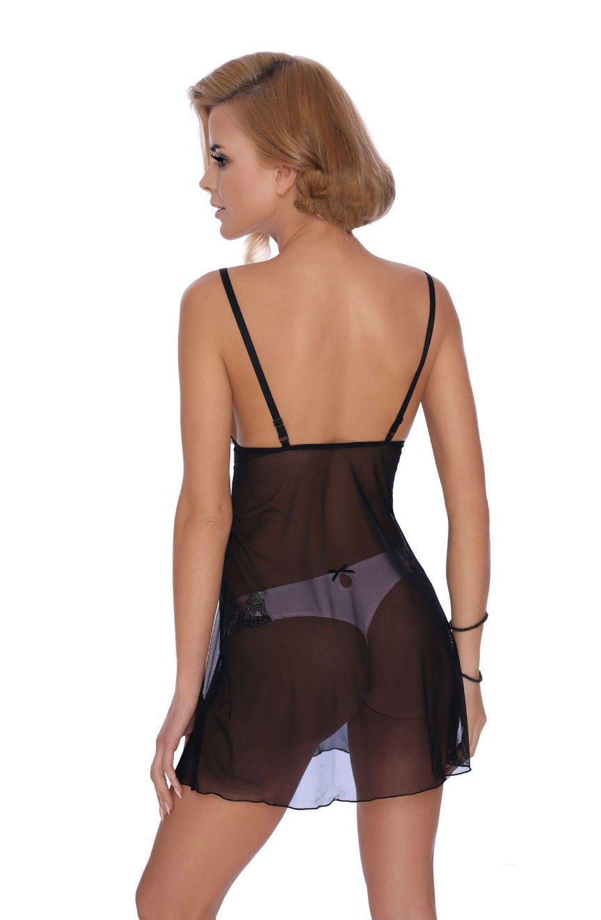 A person with short blonde hair is standing with their back to the camera, wearing a Roza Natali Chemise in pink. Featuring adjustable straps, the chemise reveals matching black underwear underneath and sports elegant embroidery throughout. The person has their hand by their side.