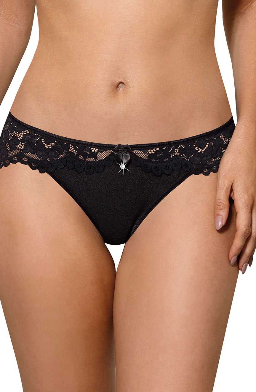 A person wearing Roza Newia Black Briefs adorned with a satin ribbon bow and a star charm at the waistband. The image focuses on the midsection, showcasing the detailed all-over lace design and the seamless fit of the underwear from the Roza brand.