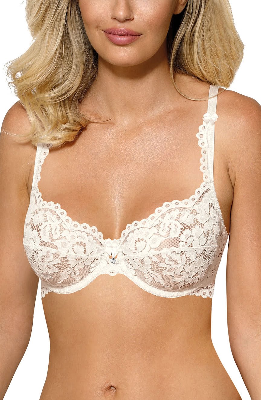 A woman wearing an ivory, lace soft cup bra from the Roza Newia collection. The bra features intricate floral patterns and small bow details on the straps. The photograph focuses on the upper torso, showcasing both design and fit, with her shoulders and part of her neck visible. Mix or match options available.