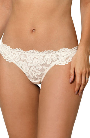 A person is seen from the waist to mid-thigh wearing the Roza Newia Ivory Thong, designed by Roza. The thong showcases intricate floral lace patterns and a delicate scalloped edge. The person's nails are neatly manicured and painted in a light, neutral color.