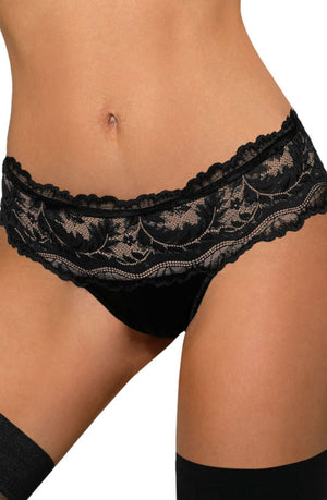 A person is wearing the Roza Sefia Thong Black, known for its intricate floral lace patterns, paired with black thigh-high stockings from the Sefia Collection. The image is cropped to show only the midsection and upper thighs.