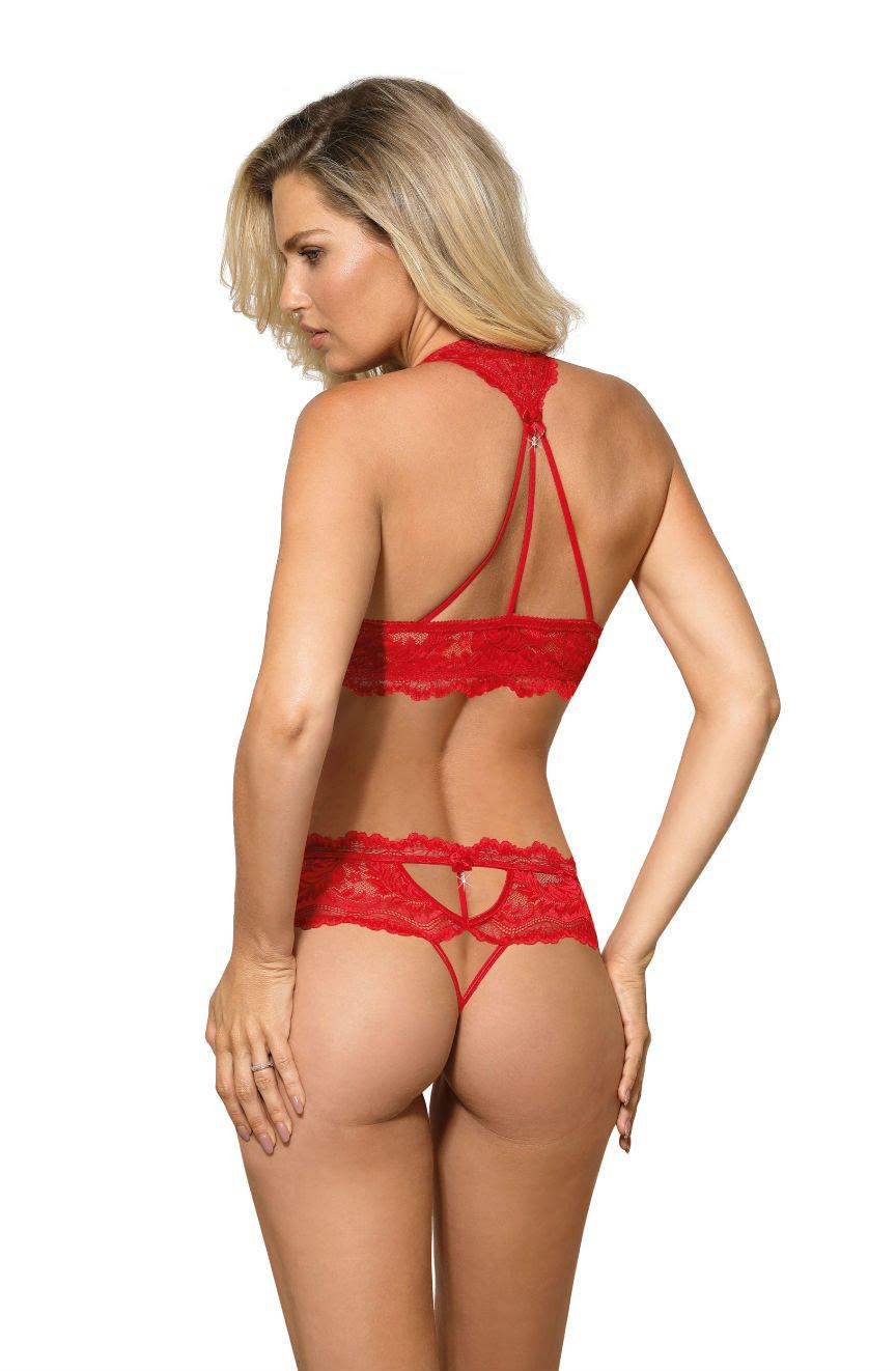 A woman with blonde hair is seen from the back, wearing the Roza Sefia Thong Red lingerie set from Roza, featuring a red lace halter bralette with intricate lace patterns and strappy details, adorned with a satin ribbon bow. The matching panties showcase exquisite cut-out lace designs. The background is plain white.