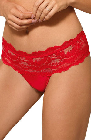 A person is shown wearing the Roza Sefia Thong in red, featuring a floral pattern and a delicate satin ribbon bow. The scalloped waistband is sheer. Their hands rest near their waist as they stand against a plain background. This elegant piece is crafted by the brand Roza.