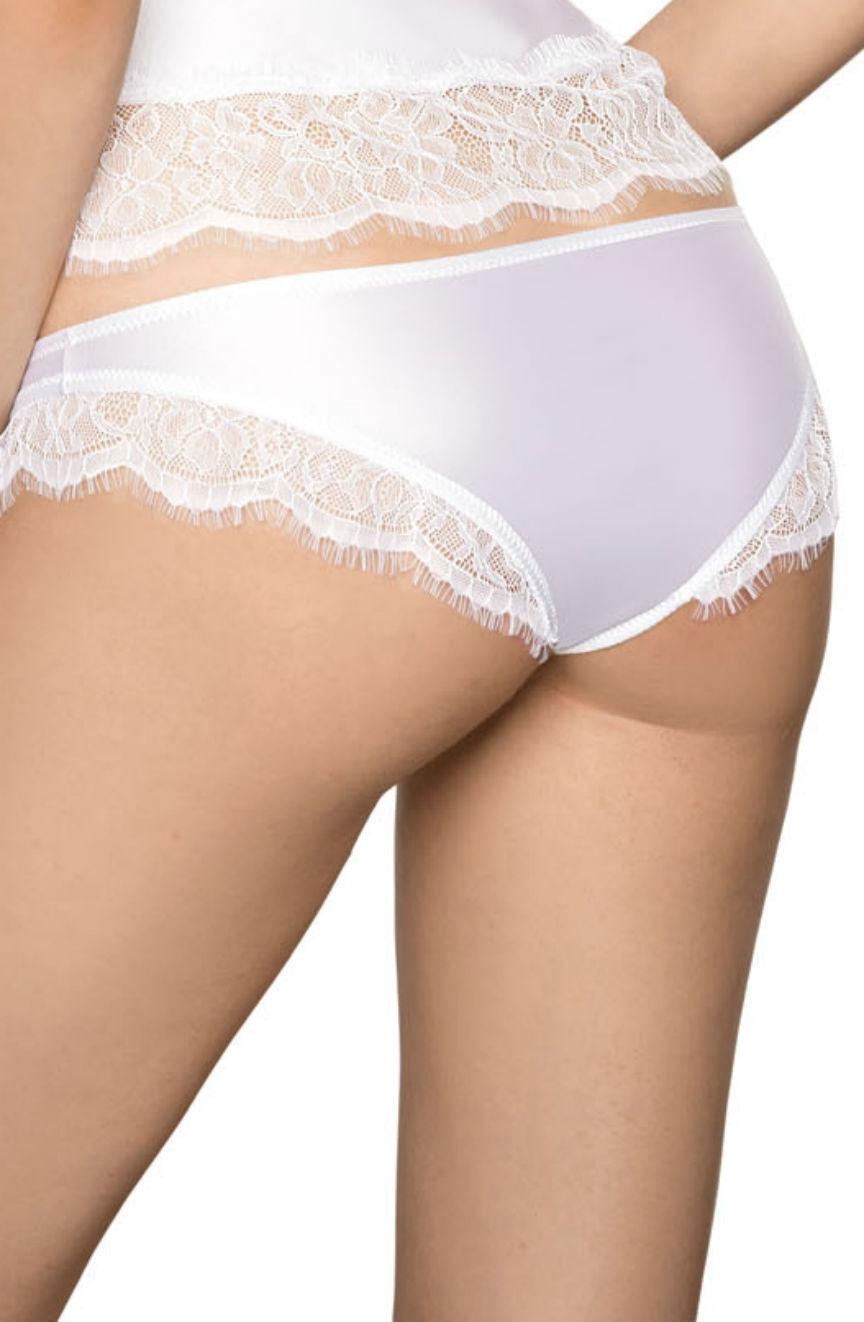 A person wearing the Roza Sija White Brief by Roza and a matching white top is shown from the waist down, turned slightly to the side. The white satin fabric and delicate eyelash lace details are prominent.