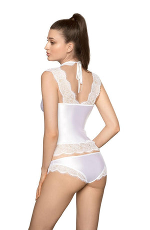 A model with long brown hair in a high ponytail is standing and facing away, showcasing a white lace lingerie set, specifically the Roza Sija White Shirt from the Roza collection. This stunning piece includes a halter neck camisole with matching underwear. The camisole features delicate eyelash lace detailing on the shoulders and hem, enhancing its allure.