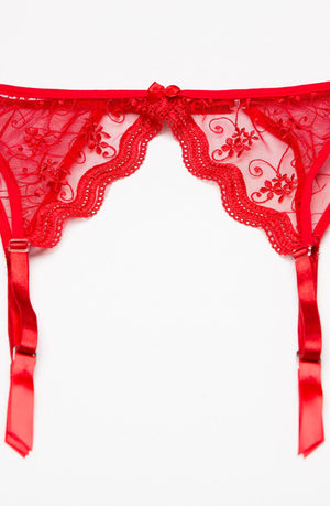 The Shirley Of Hollywood 622 Garter Belt Red by Shirley of Hollywood is a red lace garter belt adorned with floral embroidery and attached adjustable garter straps. Available in plus sizes, this piece features a small bow at the center of the waistband and intricate lace with scalloped edges. The embroidered lingerie is showcased against a plain white background.