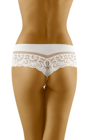 A woman stands with her back facing the camera, wearing the Wolbar Cantata White Thong Shorts. The delicate lace panel adorns her lower back, hips, and upper thighs, elegantly showcasing the intricate floral lace details against her skin on a plain white background.