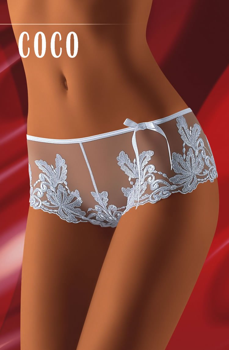 Close-up of a fashionista wearing lace-trimmed, semi-sheer underwear in light blue. The underwear features intricate floral embroidery and a small bow on the side. The background is a red, silky fabric, with "Wolbar" displayed at the top left corner: a true Wolbar Coco Black Shorts masterpiece.