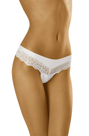 A close-up image of a person wearing the Wolbar Sirtaka White Thong by Wolbar. The white lace-trimmed thong features intricate lace detailing around the waistband and leg openings, adding to its delicate lace design. The background is not visible, focusing solely on the midsection and upper thighs.